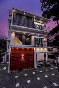 a modern house with a red garage at Dune Homestay in Alleppey