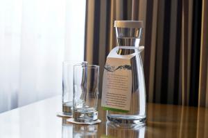 a bottle and a glass on a table at Holiday Inn Vienna City, an IHG Hotel in Vienna