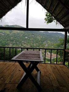 a picnic table on a wooden deck with a view at Glenview hotel & homestay in Kandy