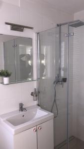 a white bathroom with a sink and a shower at Naturheilcamp Götzer Berge in Groß Kreutz