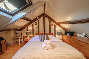 a bedroom with a bed with two slippers on it at Le Saint Salomon - Appartement Duplex in Vannes