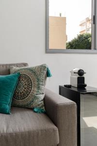 a couch with a pillow on it in a living room at Sienna Sky by HolyGuest in Tel Aviv