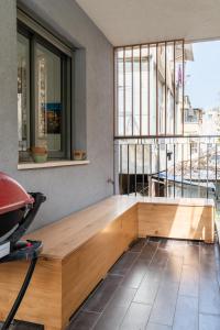a room with a wooden bench in front of a window at Sienna Sky by HolyGuest in Tel Aviv