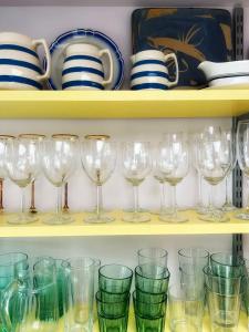 a bunch of wine glasses on a shelf at Odun Terrace in Appledore