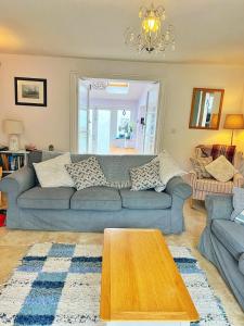 a living room with a couch and a table at Odun Terrace in Appledore