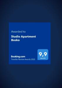 a blue background with a sign that reads awarded to studio apartment bosota at Studio Apartment Bosko in Novalja