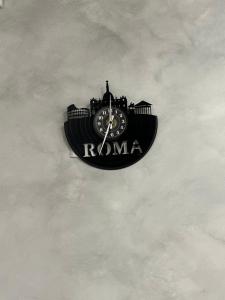 a clock with roma written on it in the sky at LA LOGGIA in Rome