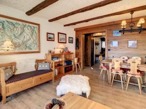 a living room with a table and a couch at Porthos 29-30 in Verbier +17 photos