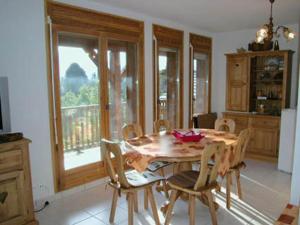 a dining room with a wooden table and chairs at Appartement Samoëns, 3 pièces, 6 personnes - FR-1-629-17 in Samoëns