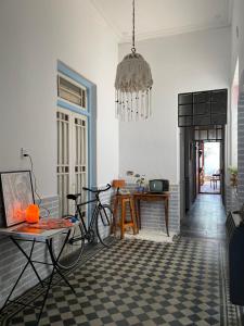 a living room with a bike and a chandelier at Mucho Bonito Hostel in Santa Fe +28 photos