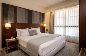 Ένα ή περισσότερα κρεβάτια σε δωμάτιο στο Olive Tree Hotel