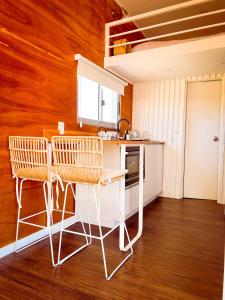 a kitchen with a table and two chairs in it at Tiny House Aire en La Juanita in José Ignacio