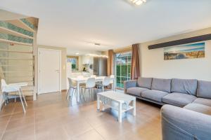 a living room with a couch and a table at Casa Kids in De Panne