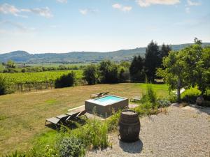 un jardin avec une piscine et un tonneau dans l'établissement Corte Massimago, à Mezzane di Sotto