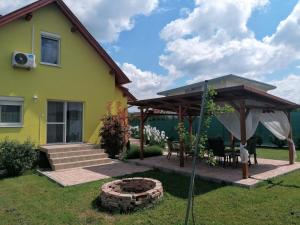 Casa amarilla con patio y sombrilla en Éva Háza Nyugalom/Pihenés/Relax, en Sopron