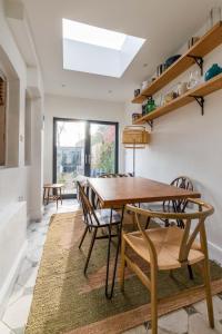 a dining room with a wooden table and chairs at Lindley Terrace - Norfolk Holiday Properties in Norwich