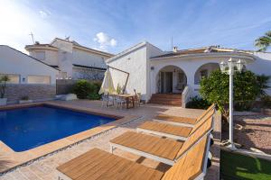 a backyard with a swimming pool and a house at Casa Velazquez in Rojales