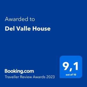 a blue sign with the text awarded to del valle house at Del Valle House in Ica