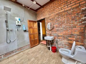 a brick bathroom with a shower and a toilet at Villa Mak Intan, Che'Pa Village Langkawi in Kuah +12 photos