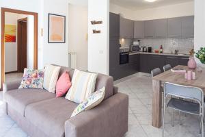 a living room with a couch and a kitchen at ANDREA Apartment in Levanto