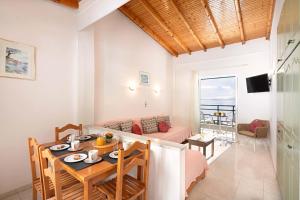 a dining room and living room with a table and chairs at Nissaki Sea View 203 by Sealand Villas in Nisakion