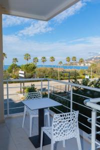a table and chairs on a balcony with a view of the ocean at Seaview Apartments in Vlorë