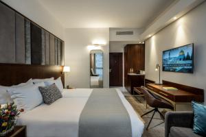 Ένα ή περισσότερα κρεβάτια σε δωμάτιο στο Olive Tree Hotel