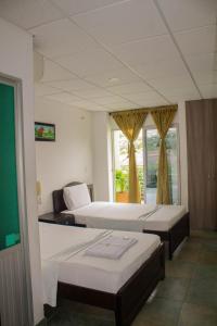 Cama o camas de una habitación en Hotel Orinoquia Real