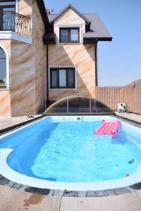 a swimming pool in front of a house at Agroturystyka nad Nidą in Włoszczowa