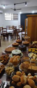 a table filled with lots of different types of food at Hotel Village Cataguases in Cataguases