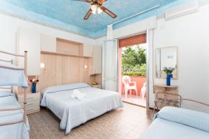 Postel nebo postele na pokoji v ubytování Hotel Minerva