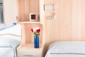 Postel nebo postele na pokoji v ubytování Hotel Minerva
