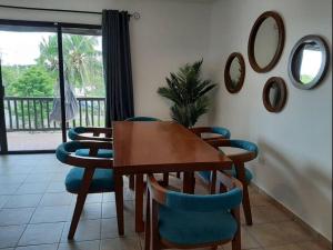 a dining room with a table and chairs and mirrors at Sunset Condo @ Villas Mayaluum in Cozumel