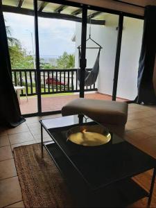 a living room with a coffee table and a chair at Sunset Condo @ Villas Mayaluum in Cozumel