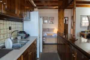 cocina con fregadero y dormitorio con cama en Stathohouse, en Filiatra