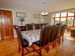 a dining room table with leather chairs and a table and chairsktop at Manor Wood in Coddington