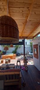 a patio with a wooden ceiling and a large light fixture at Mucho Bonito Hostel in Santa Fe
