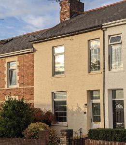 a brick house with a chimney on top of it at Penarth Town Terrace, close to cafes, beaches, Cardiff in Cardiff