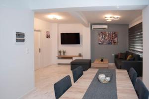 a living room with a couch and a table at Oniro Home in Ierápetra