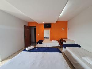 um quarto de hotel com duas camas e uma secretária em Hotel Supreme - Pistão Sul - Próximo ao Taguatinga Shopping em Taguatinga