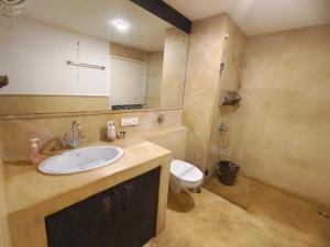 a bathroom with a sink and a toilet at VILLA M - SOLITUDE 2 CANDOLIM GOA 3BHK, Pool Facing, Near Beach, Free Breakfast, Free WIFI and Prime Location in Candolim