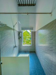a bathroom with a shower with a window at Chon's Dock Homestay & House Lease in Phan Thiet