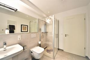 a bathroom with a sink and a toilet and a shower at Seeblick Roter Sand in Wangerooge +10 photos