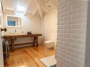 a bathroom with a sink and a toilet at Casa Som do Rio in Ponte de Lima