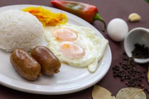 a plate of food with rice and eggs on a table at Tanaw sa Anilao in Mabini