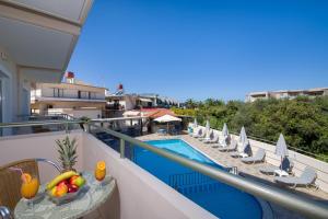 a balcony with a view of a swimming pool at Dias Hotel Apartments in Agia Marina Nea Kydonias