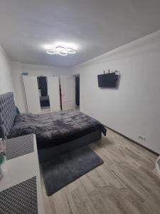 a bedroom with a bed and a couch in it at UNIRII 107 in Constanţa