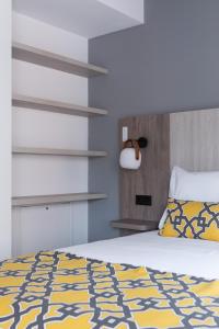 A bed or beds in a room at Apartamentos Las Torres