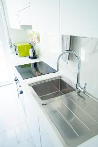 a kitchen with a sink in a white kitchen at MICKY HOUSE in Sanremo