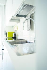 a white kitchen with a sink in a kitchen at MICKY HOUSE in Sanremo